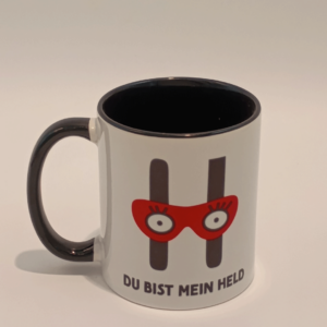 Tasse mit Logo des Verlags Edition Helden sowie dem Spruch "Du bist mein Held!"